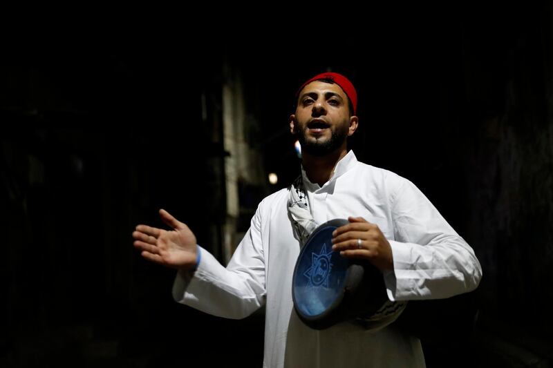 Hamodah Zakout, a Palestinian musaharati, beats a drum to wake people for their pre-dawn suhoor meal at Shati refugee camp in Gaza City. AP Photo