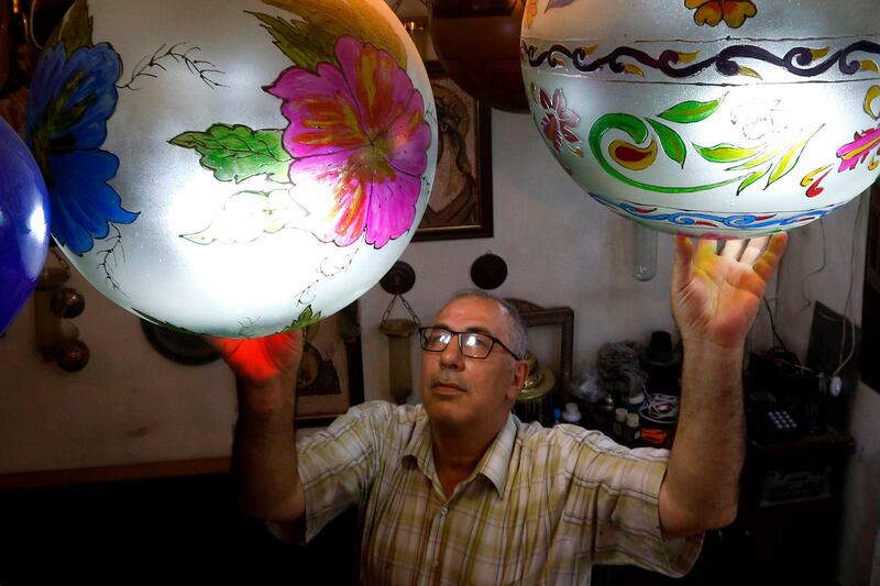 Syrian Mohamed Al Hallak is pictured at a glass-blowing workshop in Damascus. AFP