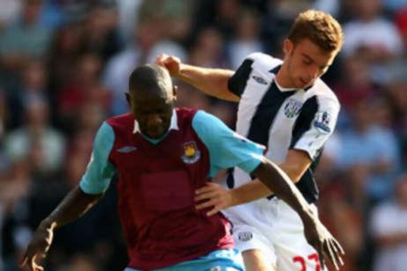 West Ham's Herita Ilunga holds off West Brom's James Morrison during Saturday's Premier League game, the first time since the league was formed in 1992 that neither side had a shirt sponsor.