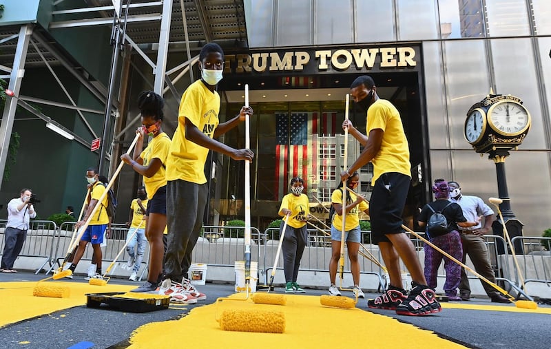 Activists paint a new Black Lives Matter mural outside of Trump Tower on Fifth Avenue in New York City. AFP