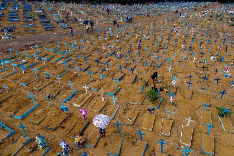 People visit a cemetery on Mothers Day, in Manaus, Amazonas State, Brazil. Cemeteries in Brazil opened this weekend for the first time for the public since the start of the Covid-19 pandemic. AFP