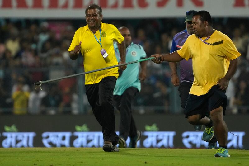 Ground staff remove a snake from the field of play during the second T20 between India and South Africa in Guwahati on Sunday, October 2, 2022. AP