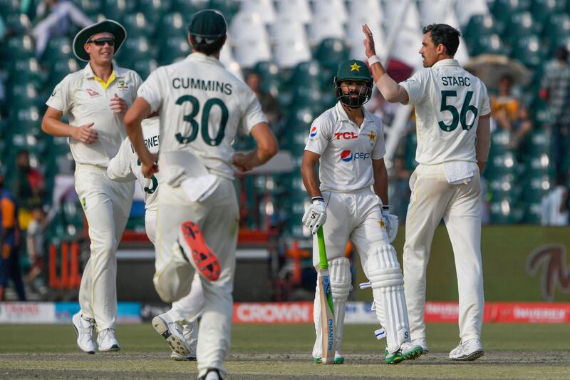 Australia's Mitchell Starc celebrates with teammates after castling Pakistan's Fawad Alam. AFP