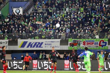 Supporters wearing masks attend a J-League match in Hiratsuka on February 21, 2020. Japan football officials on Tuesday announced that midweek cup matches had been postponed because of the outbreak of the coronavirus in the country. EPA