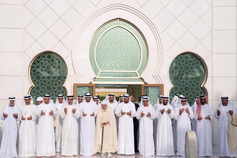 ABU DHABI, UNITED ARAB EMIRATES - June 15, 2018: (R-L) HH Sheikh Saeed bin Mohamed Al Nahyan, HH Sheikh Tahnoon bin Zayed Al Nahyan, UAE National Security Advisor, HH Lt General Sheikh Saif bin Zayed Al Nahyan, UAE Deputy Prime Minister and Minister of Interior, HH Sheikh Nahyan Bin Zayed Al Nahyan, Chairman of the Board of Trustees of Zayed bin Sultan Al Nahyan Charitable and Humanitarian Foundation, HH Sheikh Hazza bin Zayed Al Nahyan, Vice Chairman of the Abu Dhabi Executive Council, HH Sheikh Mohamed bin Zayed Al Nahyan, Crown Prince of Abu Dhabi and Deputy Supreme Commander of the UAE Armed Forces, HE Shaykh Abdallah bin Bayyah, HH Sheikh Saeed bin Zayed Al Nahyan, Abu Dhabi Ruler's Representative, HH Sheikh Mansour bin Zayed Al Nahyan, UAE Deputy Prime Minister and Minister of Presidential Affairs, HH Sheikh Abdullah bin Zayed Al Nahyan, UAE Minister of Foreign Affairs and International Cooperation, HH Sheikh Hamed bin Zayed Al Nahyan, Chairman of the Crown Prince Court of Abu Dhabi and Abu Dhabi Executive Council Member and HH Sheikh Nahyan bin Mubarak Al Nahyan, UAE Minister of State for Tolerance, pray at the tomb of HH Sheikh Zayed bin Sultan bin Zayed Al Nahyan, President of the United Arab Emirates during Eid Al Fitr prayers at the Sheikh Zayed Grand Mosque. 

( Hamad Al Kaabi / Crown Prince Court - Abu Dhabi )
---
