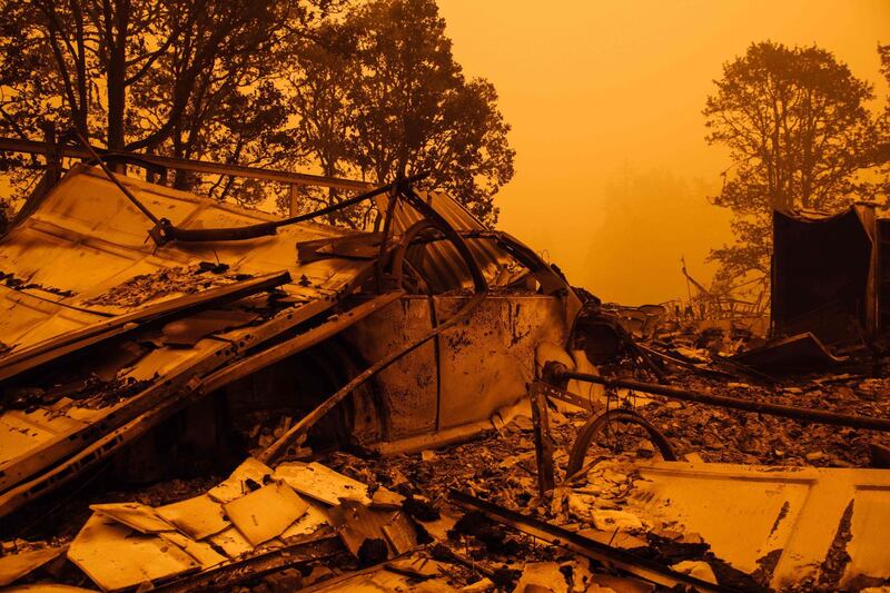 An orange smoke-filled sky and burnt remains are seen after the passage of the Santiam Fire in Gates, Oregon. AFP