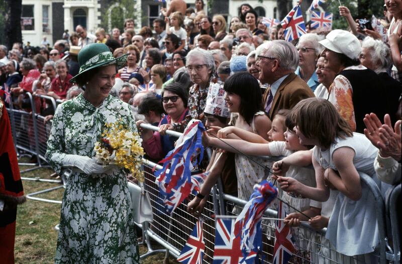 Queen Elizabeth II greets well-wishers in north London during celebrations of her Silver Jubilee, 1977. (Photo by Hulton Archive/Getty Images)