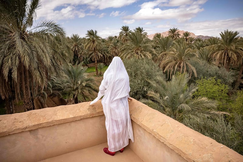 A woman stands at an observation deck overlooking the oasis town of Figuig on the border with Algeria. AFP