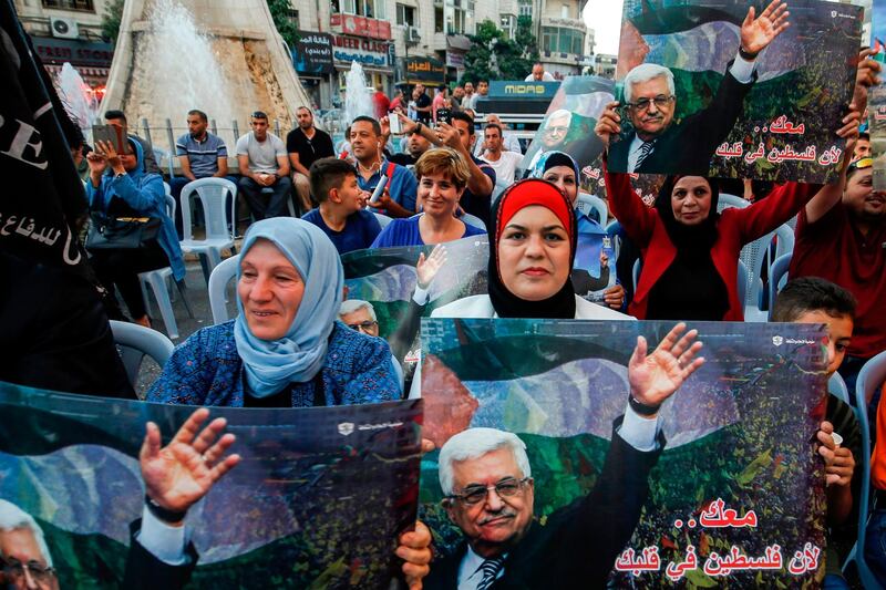 Palestinians chant slogans and wave pictures of Abbas during a demonstration in Ramallah. AFP