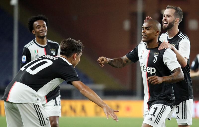 Douglas Costa, second right, celebrates after scoring the third goal. AP Photo
