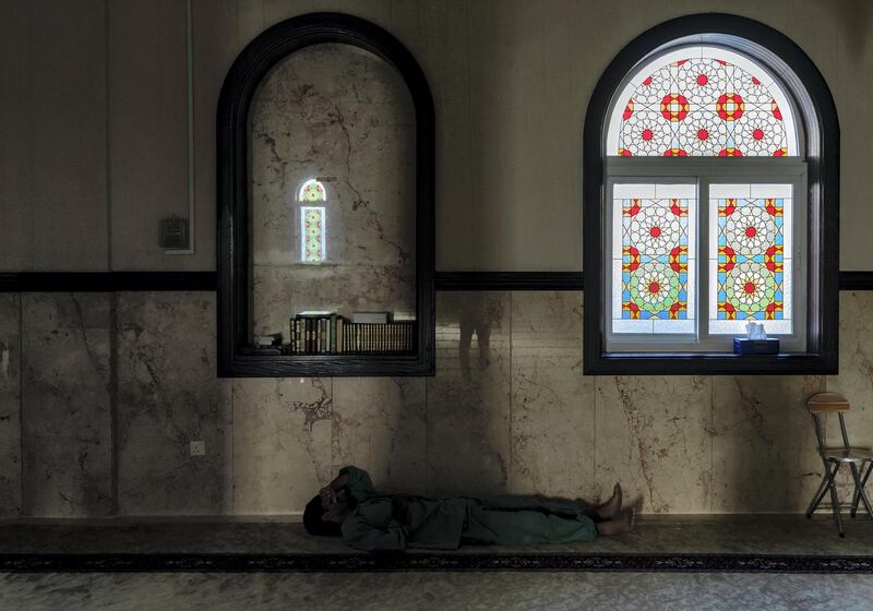 (No permission given to take this pic) 

Dubai, United Arab Emirates - May 09, 2019: Standalone. A man takes rest mosque during ramadan. Thursday the 9th of May 2019 in Dubai. Chris Whiteoak / The National
