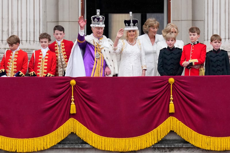 King Charles III and Queen Camilla wave to the crowds from the balcony of Buckingham Palace after their coronation ceremony. AP