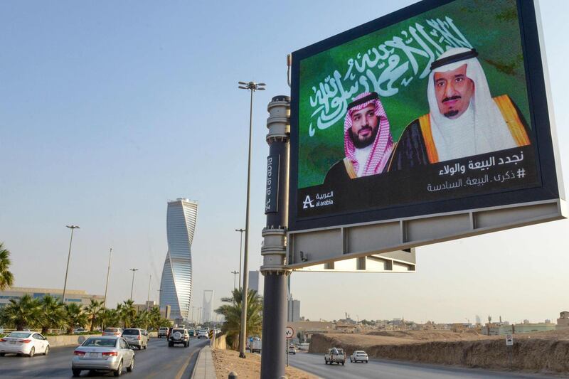 An electronic billboard bearing the portraits of Saudi King Salman bin Abdulaziz and Crown Prince Mohammed bin Salman ahead of a meeting of Finance ministers and central bank governors of the G20 nations in Riyadh.  AFP