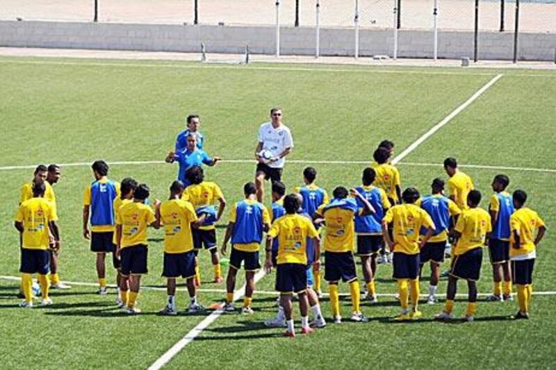 Srecko Katanec, in white shirt, directs training as the UAE team prepare for tonight’s Gulf Cup semi-final against Saudi Arabia.