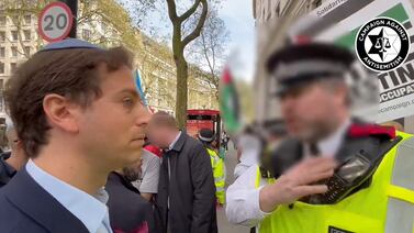 Gideon Falter, chief executive of the Campaign Against Antisemitism, speaks to a Metropolitan Police officer as a pro-Palestine march takes place in London on April 13. PA