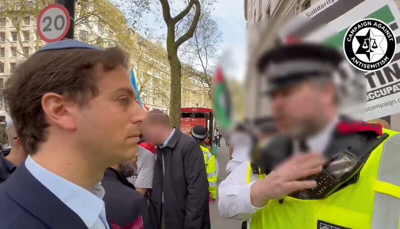 Gideon Falter, chief executive of the Campaign Against Anti-Semitism, speaks to a Metropolitan Police officer as a pro-Palestine march takes place in London on April 13. PA