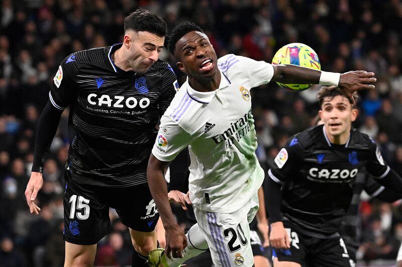 Real Sociedad defender Diego Rico challenges for a header against Vinicius Junior. AFP