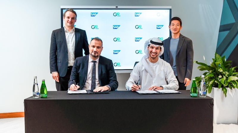 Talal Al Kaissi, chief executive of G42 Cloud, seated right, and Zakaria Haltout, managing director of SAP, signing the agreement between the two companies. Photo: G42 Cloud