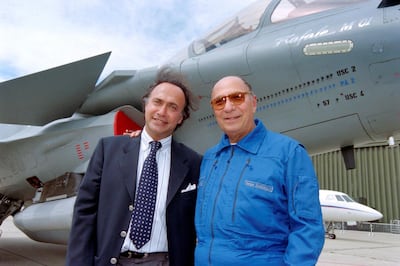 (FILES) In this file photo taken on June 11, 1997 Serge Dassault (R), Dassault Group CEO, poses with his son Olivier Dassault in front of a Rafale M01 jet fighter in Le Bourget, near Paris.  Olivier Dassault has died in the crash of his helicopter near Deauville, a parlamentiary source said on March 7, 2021. / AFP / Jack GUEZ
