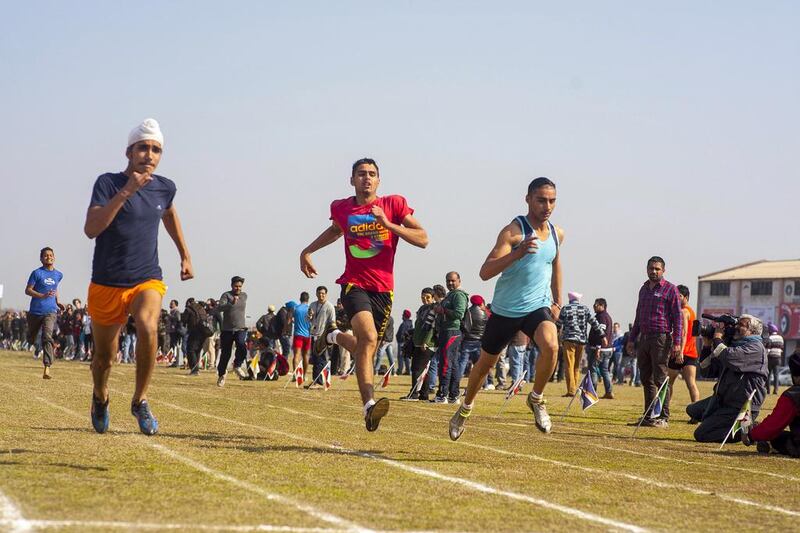 Sahejdeep Singh, left, 16, from Kurar village competes in the 100m sprint race.