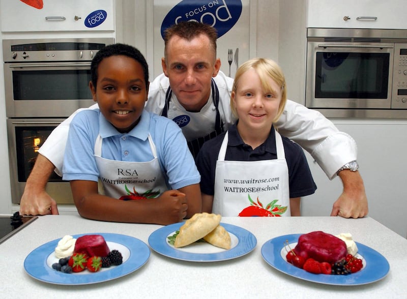 Celebrity chef Gary Rhodes gives a cooking masterclass to children from  St Peter's CofE Primary School in Hammersmith, west London on a special 'Cooking Bus' during a photocall to launch 'Focus on Food Week'.   * Focus on Food - the UK's leading food education programme for schools, holds the Tastebud Challenge annually, enabling schools around the country to celebrate cooking in their classrooms.   (Photo by Andy Butterton - PA Images/PA Images via Getty Images)