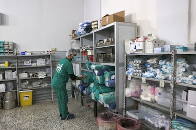 A medic gathers supplies at a hospital in the town of Harim, in Syria's Idlib province. AFP