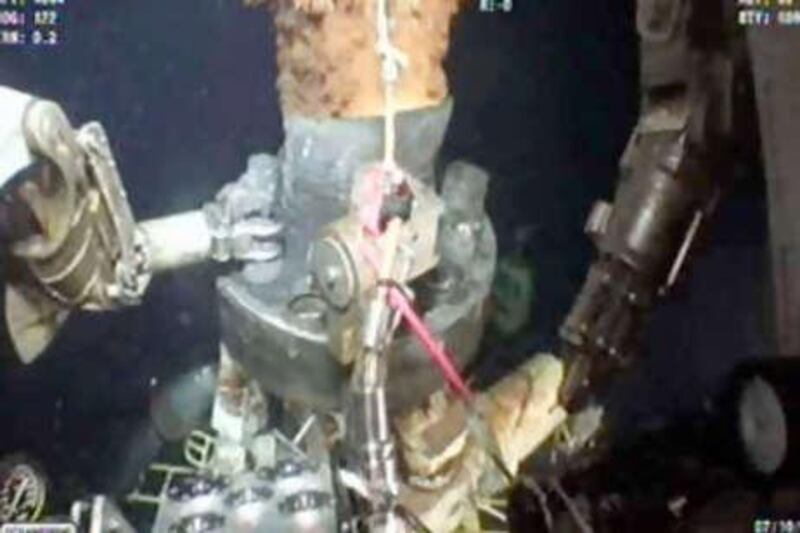 Work continues as oil leaks from BP's Gulf of Mexico well after the oil containment cap was removed so it could be replaced with a bigger cap. This frame grab is captured from a BP live video feed.