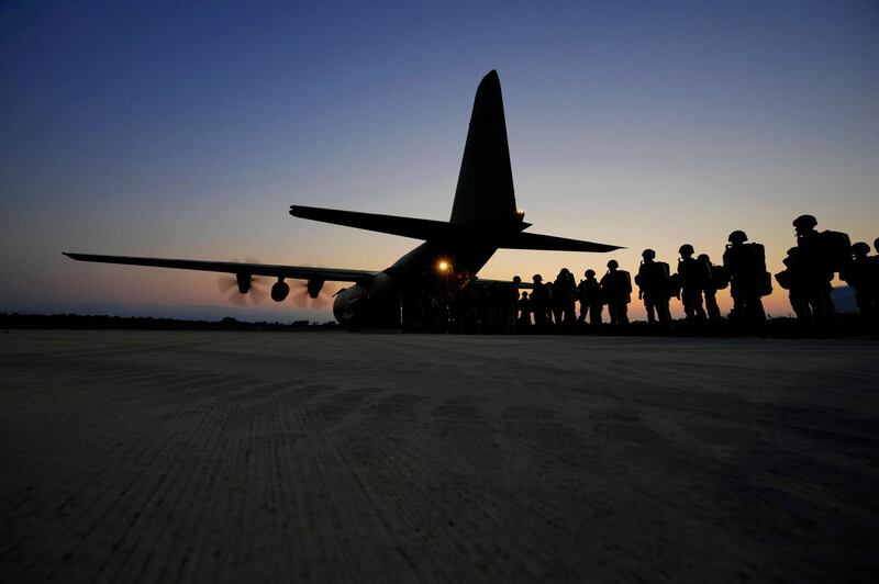 British paratroopers with the 16th Air Assault Brigade sit on the apron at RAF Akrotiri air base in Cyprus waiting to board a C130 transport aircraft for an airdrop over Jordan as part of a joint exercise with Jordanian soldiers. AP