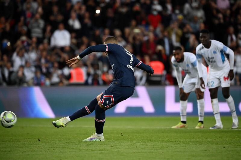Paris Saint-Germain's Kylian Mbappe scores a penalty to make it 2-1 against Marseille in first-half injury time. The match would finish with the same scoreline. AFP