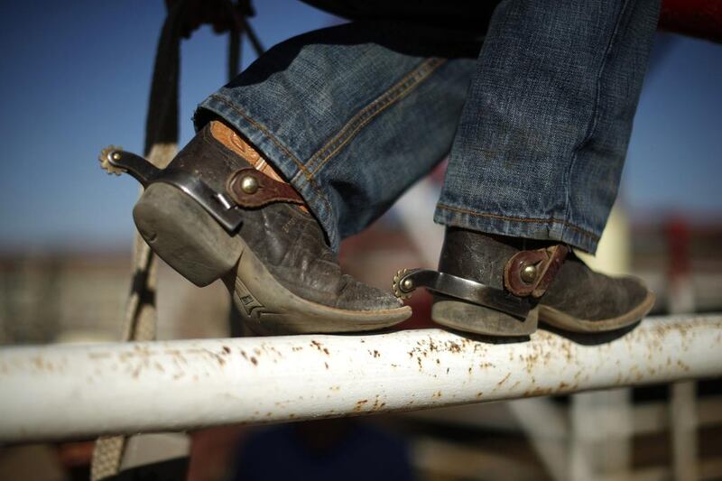 A boy wears spurs on his cowboy boots at the rodeo in Truth or Consequences, New Mexico. Many agree that Spaceport America should inject new energy into the town. Lucy Nicholson / Reuters