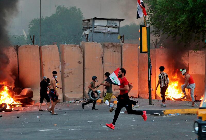 Anti-government protesters set fire in Baghdad. AP Photo