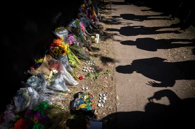 Visitors cast shadows at a memorial to the victims of the Astroworld concert in Houston. AP 