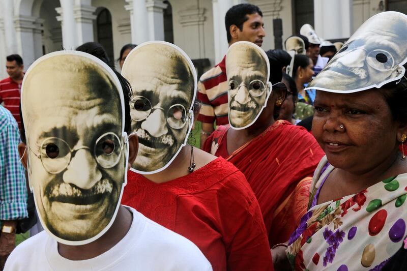 School children and teachers wearing Mahatma Gandhi masks participate in a rally to mark the independence leader's birth anniversary in Kolkata, India. Bikas Das/AP Photo