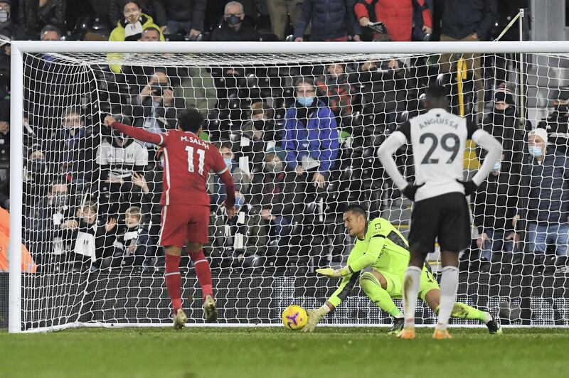 LONDON, ENGLAND - DECEMBER 13: Mohamed Salah of Liverpool  scores their team's first goal from the penalty spot past Alphonse Areola of Fulham during the Premier League match between Fulham and Liverpool at Craven Cottage on December 13, 2020 in London, England. A limited number of spectators (2000) are welcomed back to stadiums to watch elite football across England. This was following easing of restrictions on spectators in tiers one and two areas only. (Photo by Neil Hall - Pool/Getty Images)