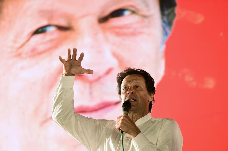 Pakistani cricket star-turned-politician and head of the Pakistan Tehreek-e-Insaf (PTI) Imran Khan addresses a political campaign rally ahead of the general election in Islamabad on July 21, 2018. 
Pakistan will hold the general election on July 25, 2018. / AFP PHOTO / FAROOQ NAEEM