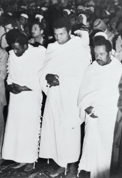 (Original Caption) Flanked by fellow pilgrims, Muhammad Ali, former heavyweight champion of the world, prays inside the Holy Mosque in Mecca recently during his New Year's pilgrimage to the spiritual center of the Moslem world. After visiting Mohammed's tomb in Medina, Ali said that he became convinced that he can defeat Joe Frazier, current heavyweight champ, if they meet in a rematch for the title.