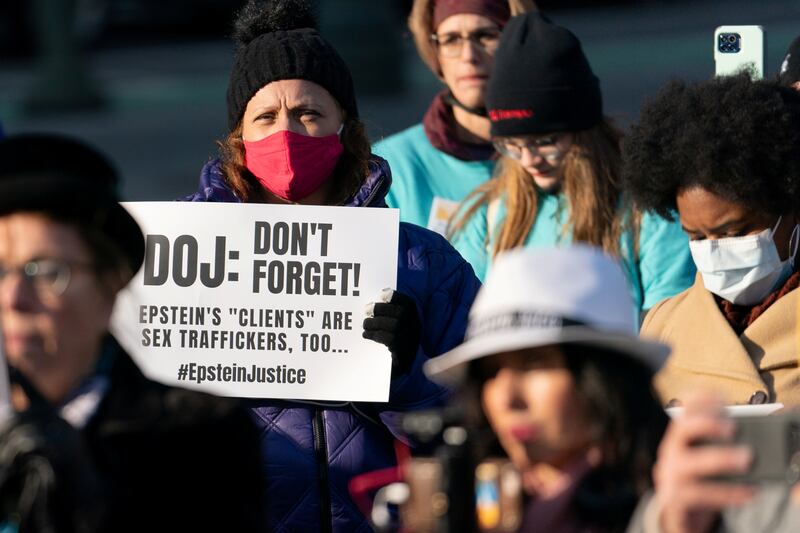 A protester holds a placard during a rally in New York City for Epstein survivors. Reuters