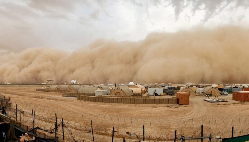 A handout photograph made available by the British Ministry of Defence shows the air around the British military base, Camp Bastion, Afghanistan, eerily still as a tidal wave of sand and dust approaches from the west. EPA