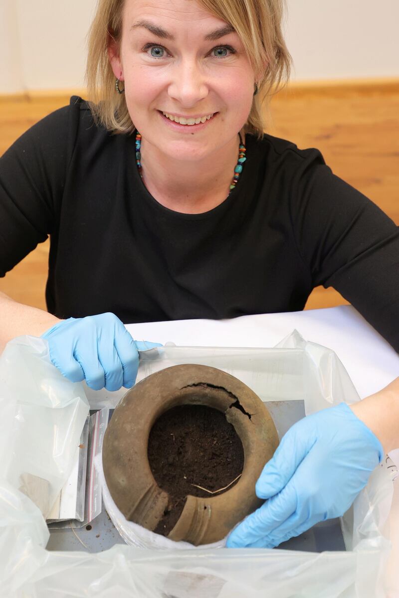 Conservator Madelene Skogbert shows a bone ring that is part of the about 50 whole or larger parts of bronze objects that have been found in Alingsas, in Gothenburg, Sweden. EPA