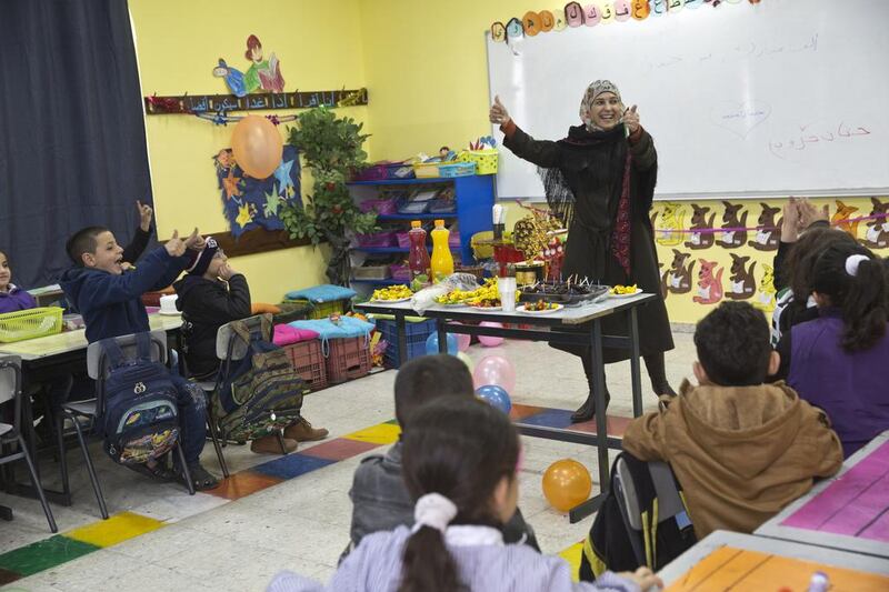 Hanan Al Hroub’s students held a surprise party for their award-winning teacher, when she returned to class on March 20, 2016. Heidi Levine for The National