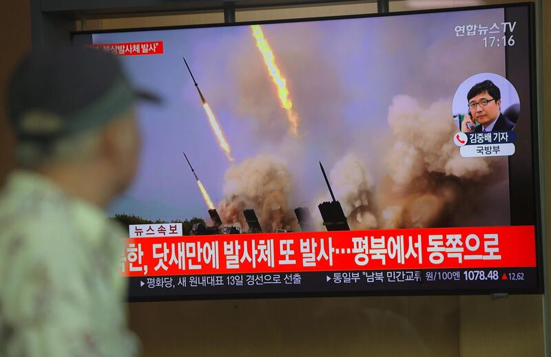 People watch a television news programme showing file footage of North Korea's projectile weapons, at a railway station in Seoul on May 9, 2019. North Korea welcomed a US envoy's visit to Seoul by firing at least one projectile for the second time in just six days on May 9, the South's military said, as Pyongyang seeks to up the ante in deadlocked nuclear negotiations with Washington. / AFP / Jung Yeon-je
