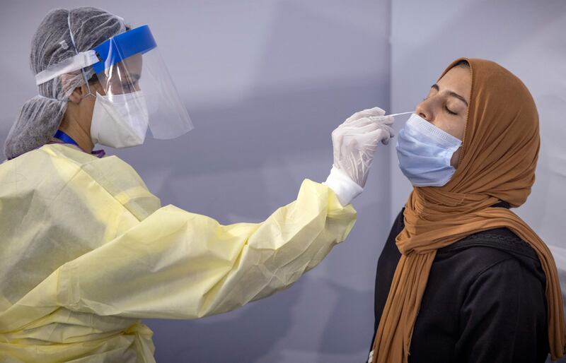 A health worker gives a PCR test. AFP