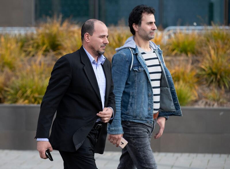 Al Noor Mosque imam Gamal Foudal, left, walks from the Christchurch High Court after the first day of the sentencing. AP