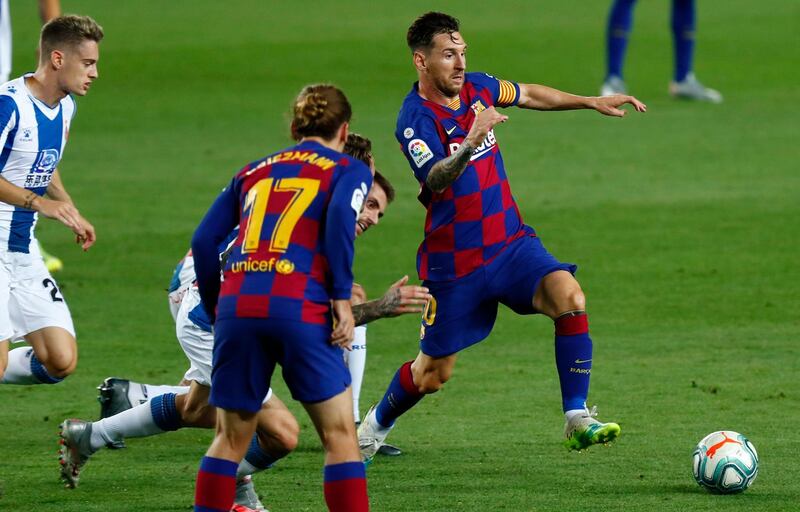Barcelona's Lionel Messi reaches for the ball against Espanyol. AP Photo