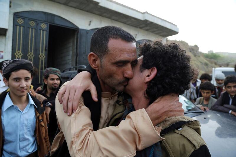 A man hugs his son after his release with other pro-government fighters in a prisoner swap between Yemeni forces and Houthis in Taez in central Yemen n June 18, 2016. REUTERS/Stringer 