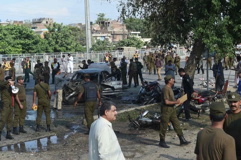 EDITORS NOTE: Graphic content / Pakistani security officals inspect the site after an explosion in Lahore on July 24, 2017.
An explosion killed at least 20 people and injured dozens in a busy vegetable market in Pakistan's eastern city of Lahore on July 24, officials said, but it was not immediately clear what caused the blast. "(The explosion) seems like a suicide blast targeting police, but we are still ascertaining the nature of the explosion," the city's commissioner Abdullah Khan Sumbul said. / AFP PHOTO / ARIF ALI