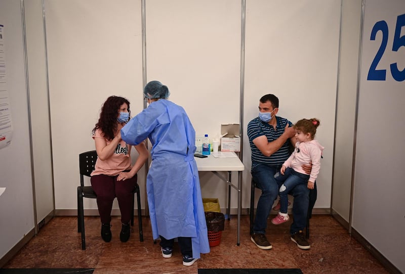 Medical staff vaccinate a family during the vaccination marathon at Bran Castle. AFP