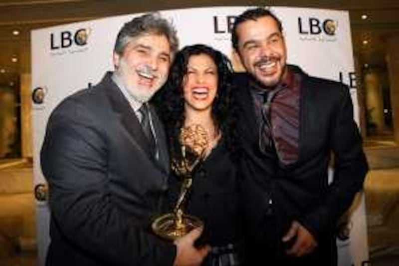 (From L-R) Syrian actor Abbas al-Nuri, Jordanian actress Siba Mubarak and Jordanian actor Munzer Rayahneh pose with an Emmy award for the series 'Al-Igtiyah' (The Invasion) at hotel in Adma, north of Beirut, on December 2, 2008. The Jordanian production won the Emmy's new telenovela category, with producer Talal Awamleh accepting the award in New York on November 24. The Lebanese satellite TV station LBCI, who had the exclusive rights for broadcasting the series, held yesterday a ceremony in honor of the producers, director and actors who contributed to the success of this artistic work. AFP PHOTO/ANWAR AMRO