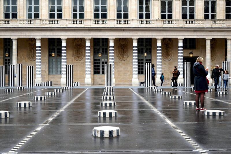 This handout picture released on May 26, 2018 and taken on April 17, 2018 by French artist and curator Jean Faucheur, shows a piece of art by French street artist Le MoDuLe De ZeeR aka LMDZ installed on the columns of the Palais Royal in Paris, facing the Colonnes de Buren by French artist Daniel Buren.
The temporary installation by LMDZ part of an exhibition "A l'échelle de la ville" hosted by French Culture Ministry has been removed weeks before the end of the event, allegedly due to moral rights' issue with Daniel Buren.  / AFP PHOTO / handout AND JEAN FAUCHEUR / Jean FAUCHEUR / RESTRICTED TO EDITORIAL USE - MANDATORY MENTION OF THE ARTISTS UPON PUBLICATION - MANDATORY CREDIT "AFP PHOTO /JEAN FAUCHEUR" -  TO ILLUSTRATE THE EVENT AS SPECIFIED IN THE CAPTION - NO MARKETING NO ADVERTISING CAMPAIGNS - DISTRIBUTED AS A SERVICE TO CLIENTS / 