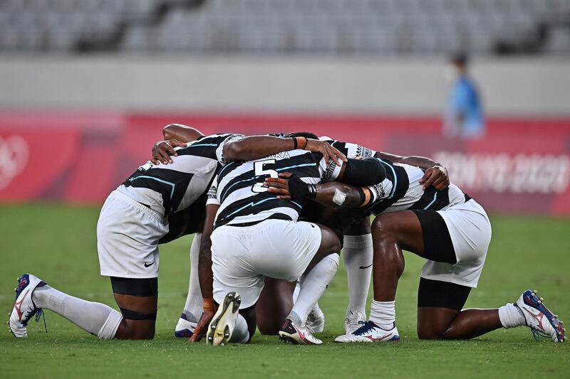 Fiji's players after retaining their title.